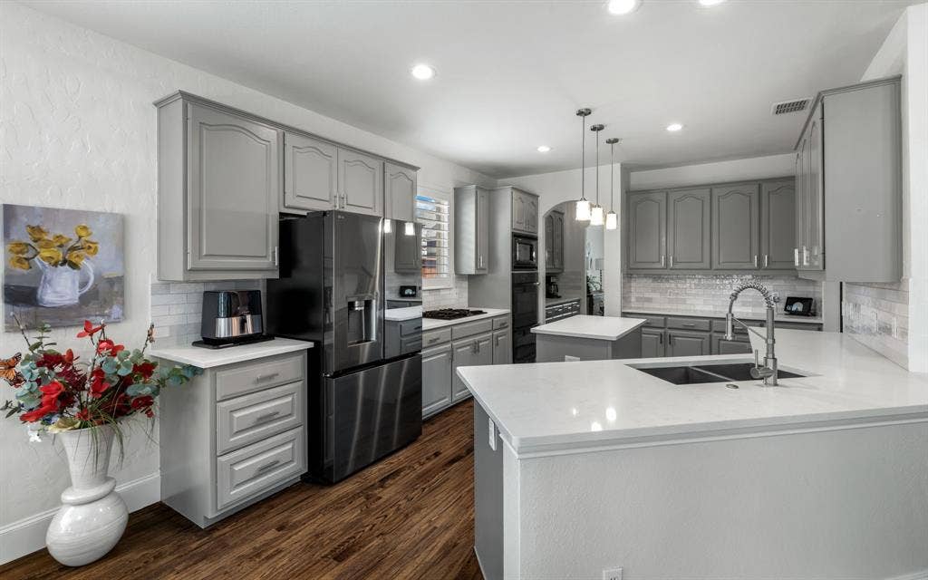 1708 Chessington Lane, McKinney, TX 75072 The well equipped kitchen features newer quartz counters, double ovens and easy access to the formal dining through the butler's pantry.