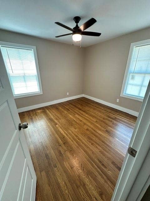 12203 Galva Drive, Dallas, TX 75243 Hardwood flooring, neutral wall tones, two windows with blinds, and a ceiling fan with integrated lighting