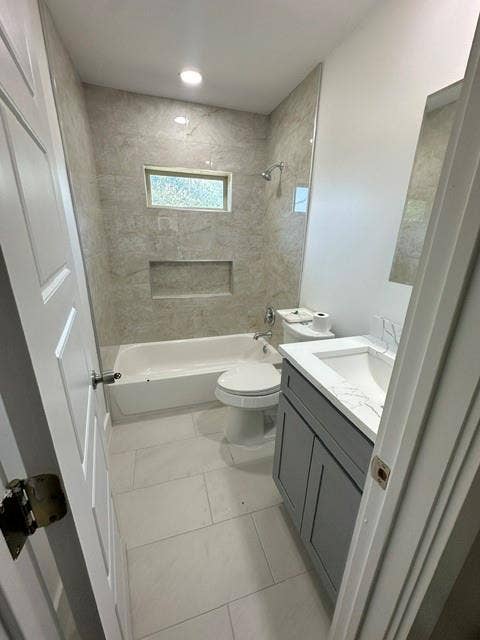 12203 Galva Drive, Dallas, TX 75243 Bathtub with tiled surround and built-in niche, single vanity with under-sink storage, and recessed lighting