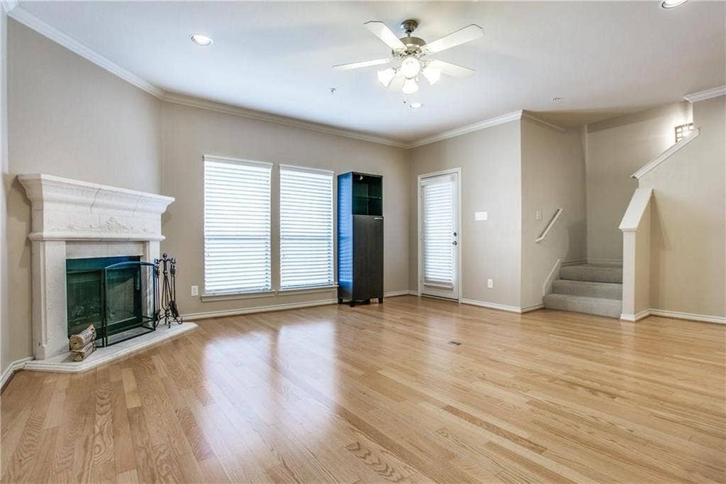 2415 Stutz Drive, #D, Dallas, TX 75235 Hardwood flooring, fireplace with a stone mantel, ceiling fan with integrated lighting, recessed lighting, and a staircase with carpeted treads