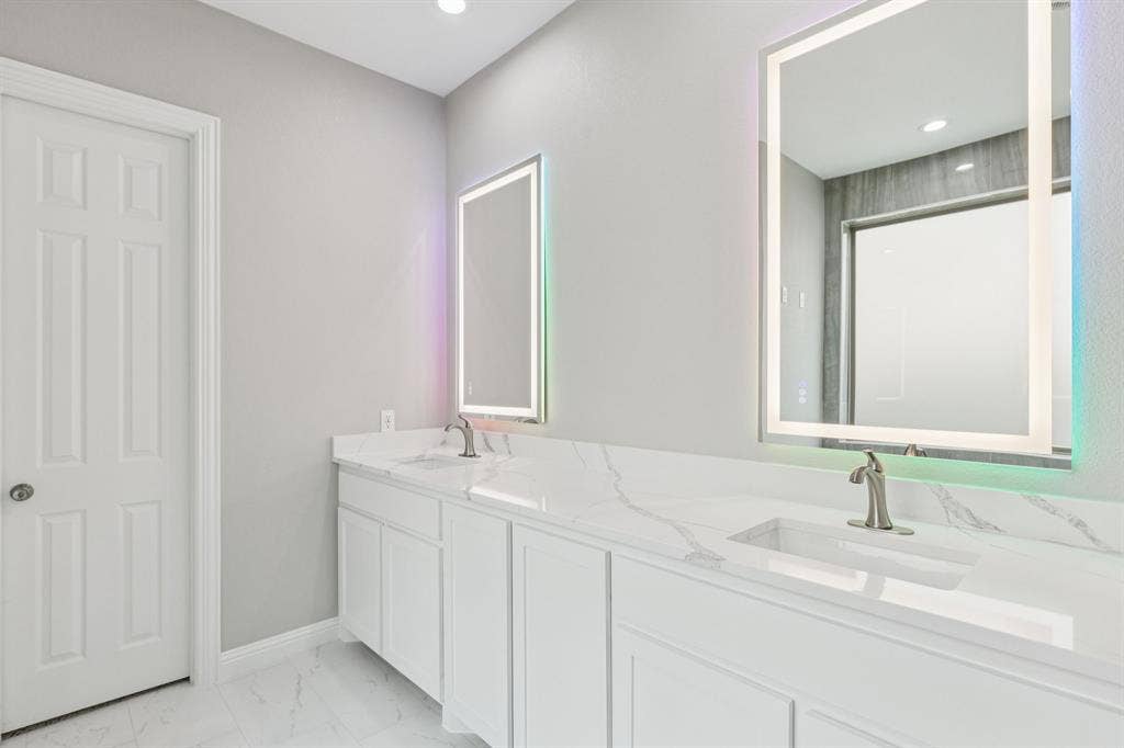 15456 Mountain View Lane, Frisco, TX 75035 Dual vanities with integrated sinks, brushed nickel faucets, and back-lit mirrors