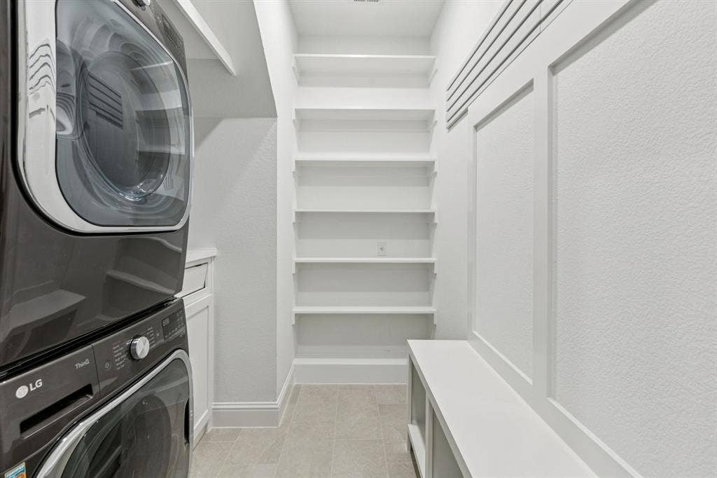 15456 Mountain View Lane, Frisco, TX 75035 Built-in shelving, tile flooring, built-in bench, and wainscoting details