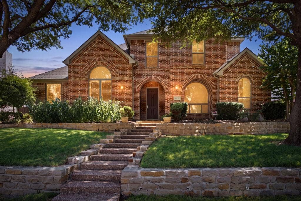 15456 Mountain View Lane, Frisco, TX 75035 Brick exterior with arched windows, stone retaining walls, and tiered stone steps