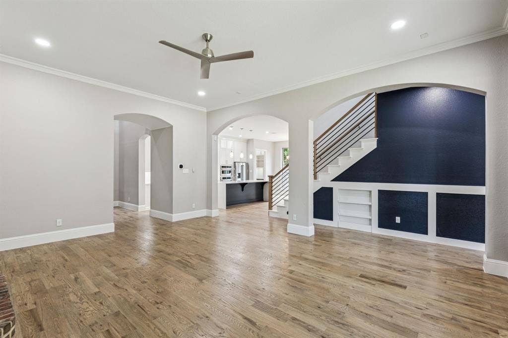 15456 Mountain View Lane, Frisco, TX 75035 Wood-finish flooring, recessed lighting, ceiling fan, arched doorways, and built-in shelving