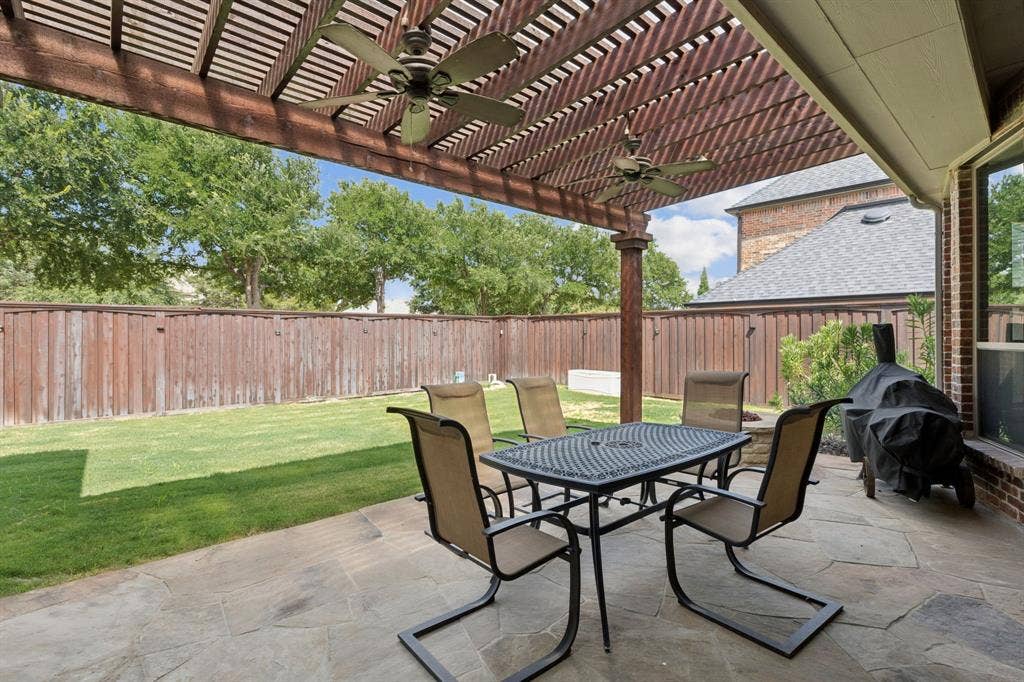 15456 Mountain View Lane, Frisco, TX 75035 Expansive patio with stone flooring and a large wood pergola