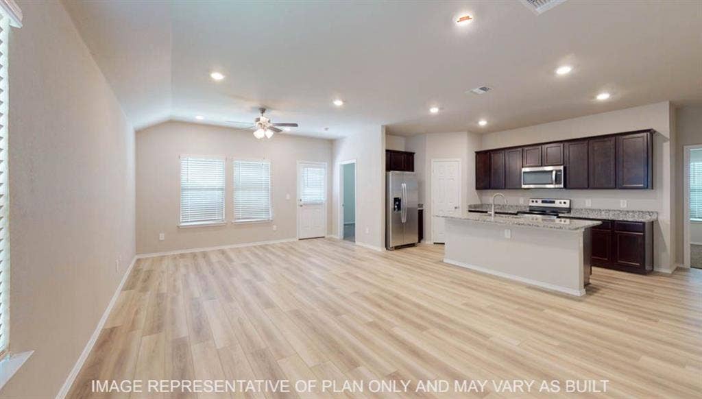 3112 Cyprian Road, Lorena, TX 76655 Vaulted ceiling, recessed lighting, wood-finish flooring, kitchen island with integrated sink, stainless steel appliances, dark wood-finish cabinetry, light-toned countertops