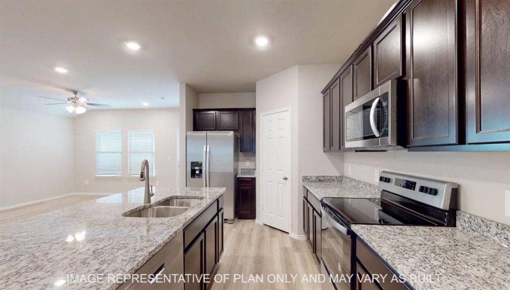 3112 Cyprian Road, Lorena, TX 76655 Kitchen featuring dark wood cabinetry, stainless steel appliances, light granite countertops, and wood-finish flooring