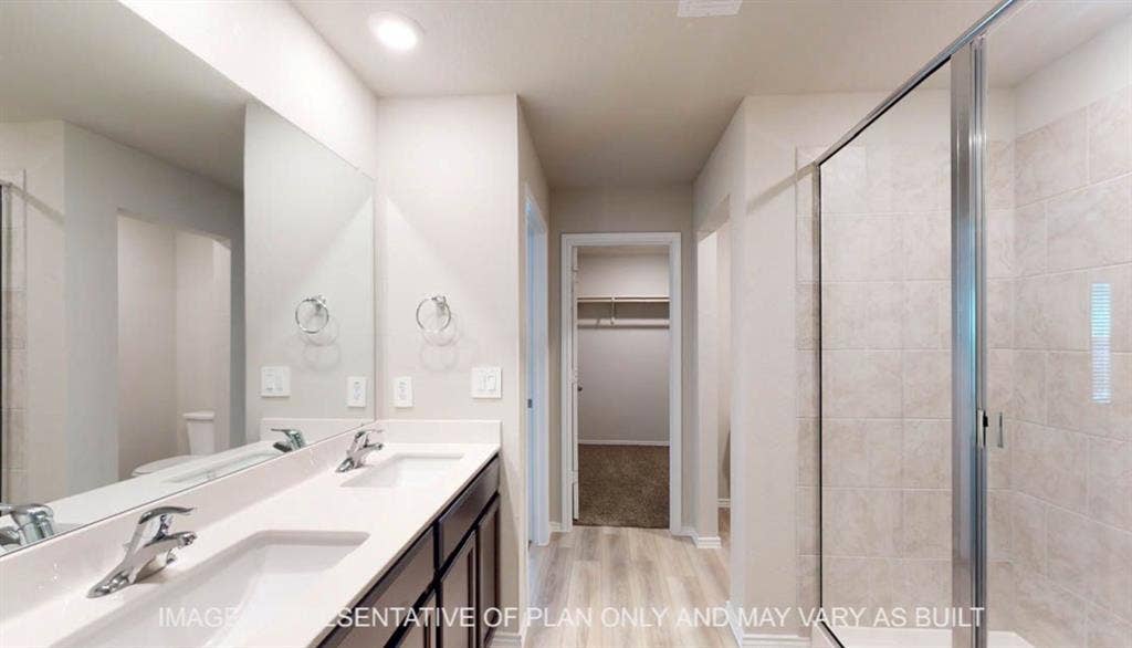 3112 Cyprian Road, Lorena, TX 76655 Dual-sink vanity with polished chrome faucets and rectangular vessel basins, paired with a wood-finish cabinetry base and light tile surround