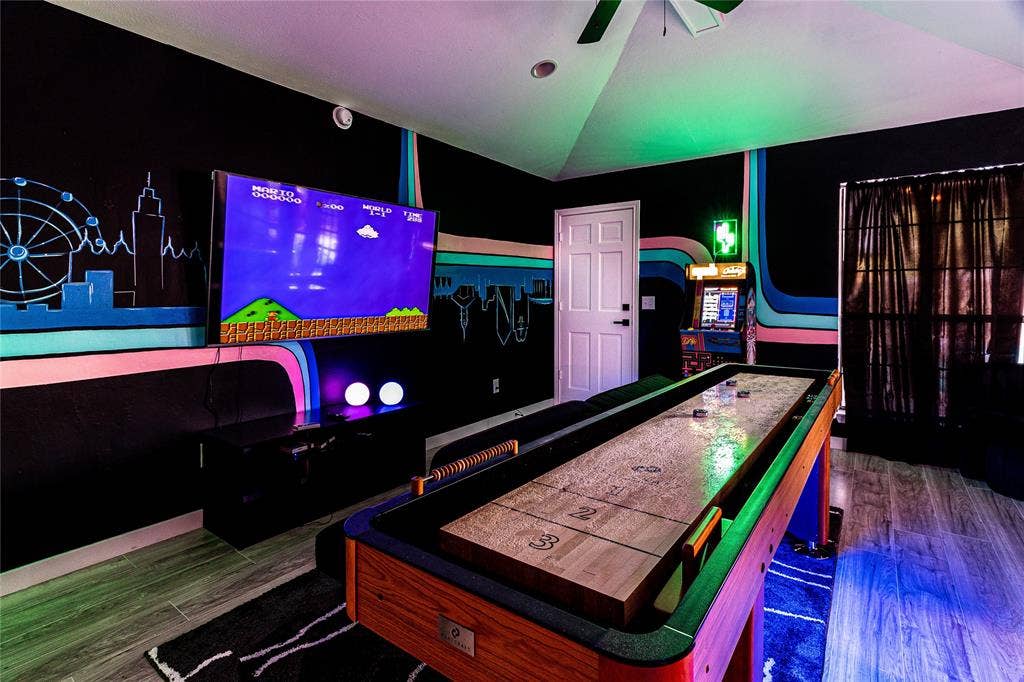 3612 Tumbril Lane, Plano, TX 75023 Shuffleboard table, mounted television, arcade game, ceiling fan, and wood-finish flooring