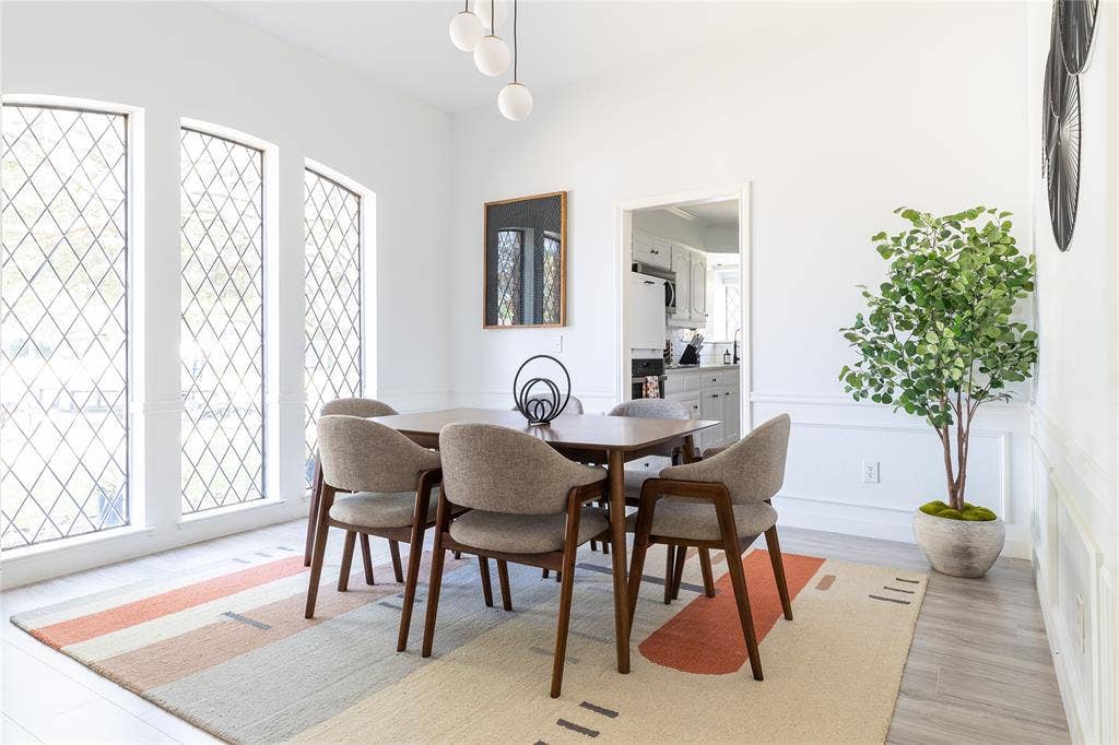 3612 Tumbril Lane, Plano, TX 75023 Three tall diamond-pane windows, decorative wall paneling, and an overhead spherical light fixture