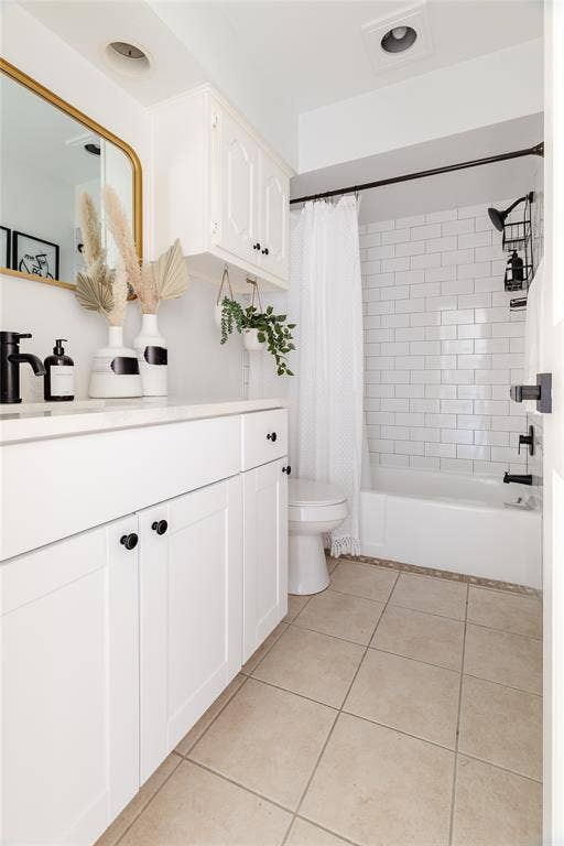 3612 Tumbril Lane, Plano, TX 75023 White vanity with matte black hardware, white subway tile shower surround, integrated white sink, bathtub with matte black fixtures, and beige floor tiling