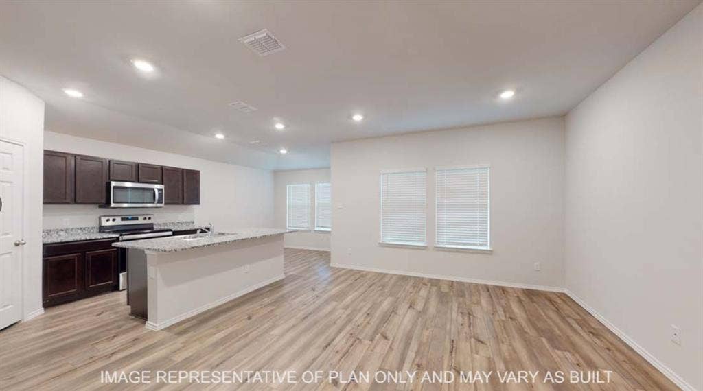10428 Neptune Court, Waco, TX 76708 Open-concept living space with wood-finish flooring, recessed lighting, and multiple windows