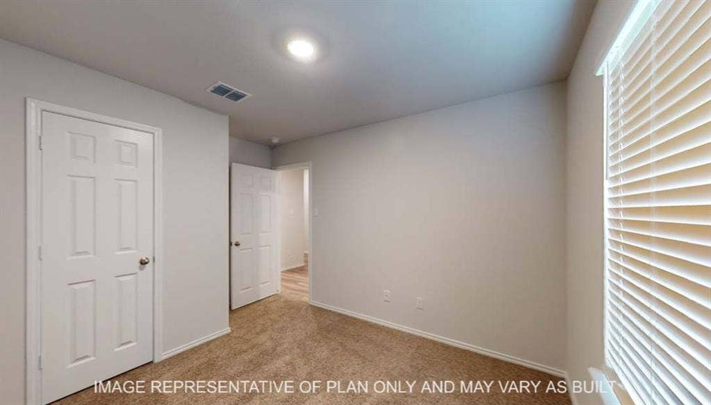 10428 Neptune Court, Waco, TX 76708 Wall-to-wall carpeting, window with blinds, recessed lighting, and white interior doors