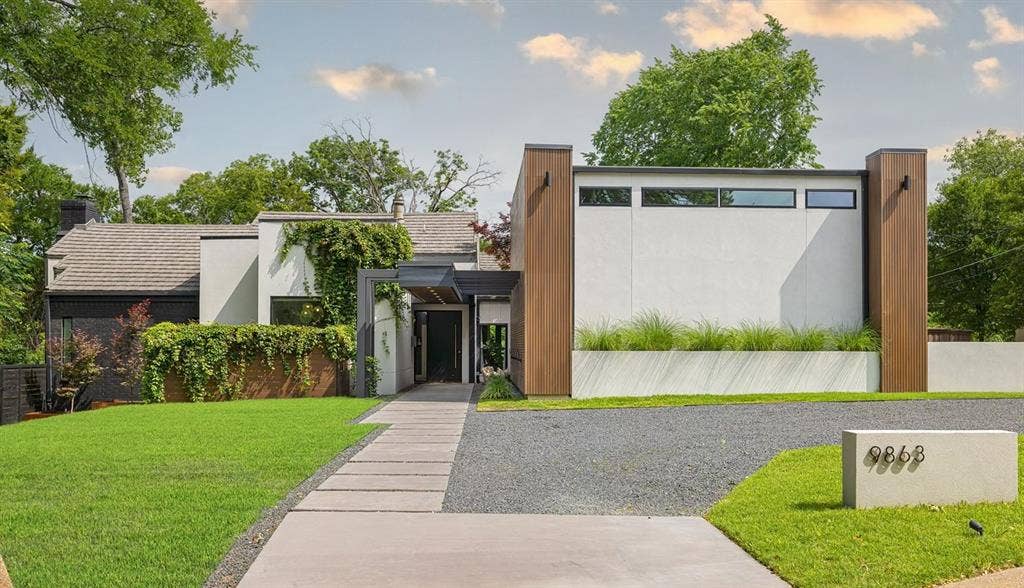 9863 Elmcrest Drive, Dallas, TX 75238 Stunning, soft contemporary architectural design featuring white stucco and wood-finish exterior with custom lighting and windows. Circle drive made of concrete and crushed granite blends right in with the exterior.
