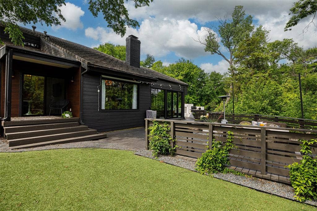 9863 Elmcrest Drive, Dallas, TX 75238 Exterior view featuring a multi-level wooden deck and artificial turf.