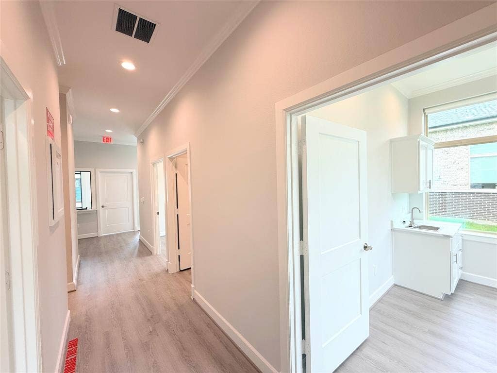 2120 Prairie Drive, 901 & #902, Prosper, TX 75078 Hallway with wood-finish flooring, recessed lighting, and crown molding