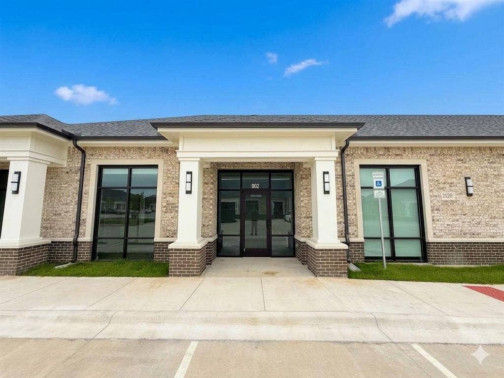 2120 Prairie Drive, 901 & #902, Prosper, TX 75078 Brick facade with white column accents, expansive glass storefront, and a prominent entry