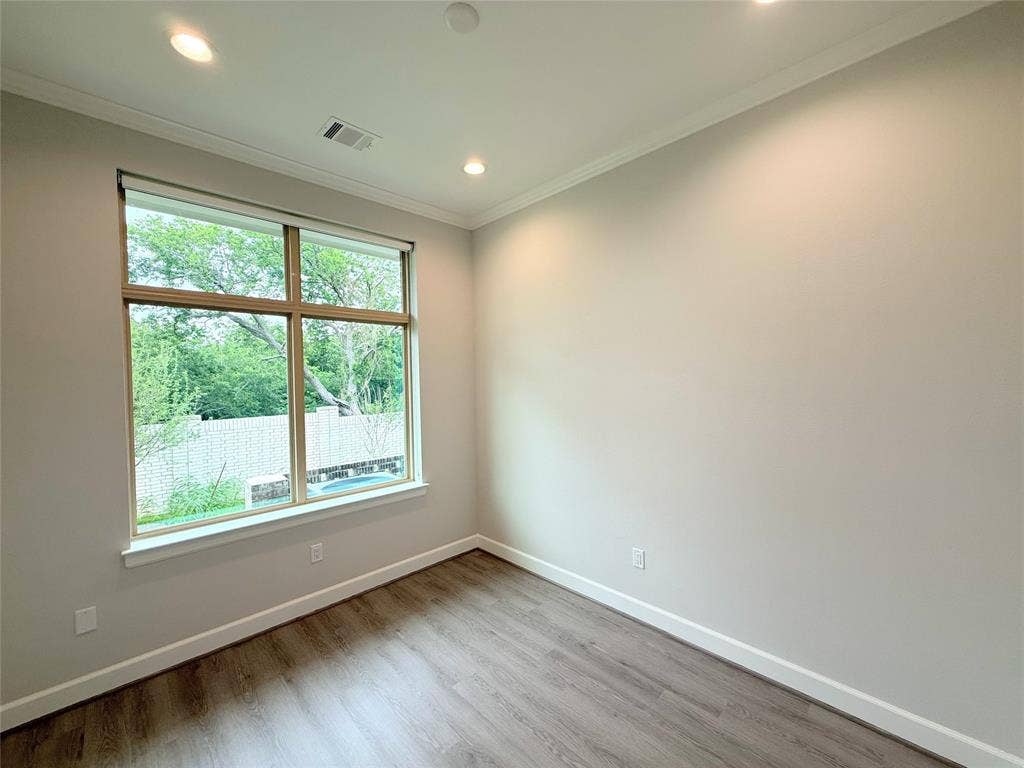 2120 Prairie Drive, 901 & #902, Prosper, TX 75078 Large window, wood-finish flooring, recessed lighting, crown molding, and neutral wall tones