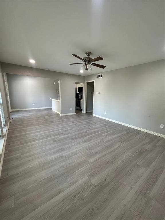 5826 Sandhurst Lane, #C, Dallas, TX 75206 Expansive room featuring wood-finish flooring, neutral paint, recessed lighting, and a ceiling fan