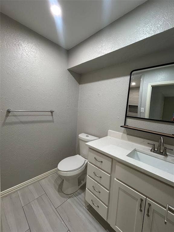 5826 Sandhurst Lane, #C, Dallas, TX 75206 White vanity with shaker-style cabinetry, a white countertop, and an undermount sink