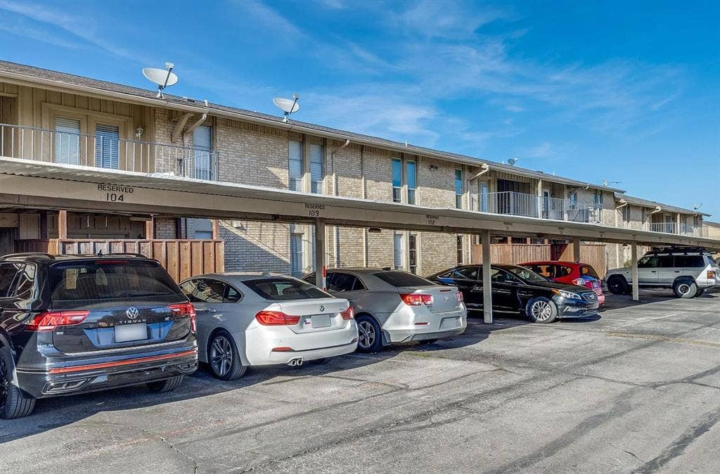 5826 Sandhurst Lane, #C, Dallas, TX 75206 Covered parking spaces with a paved lot