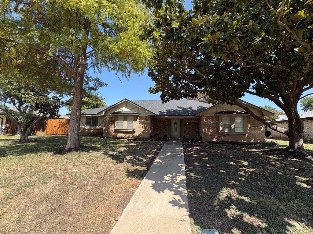 1025 Cloverdale Lane, DeSoto, TX 75115 Brick exterior with a gabled roof and a concrete pathway