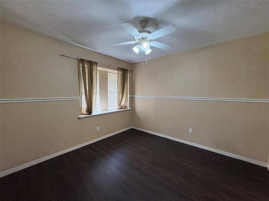 1025 Cloverdale Lane, DeSoto, TX 75115 Wood-finish flooring, ceiling fan with integrated lighting, window with a sill, and decorative chair rail molding