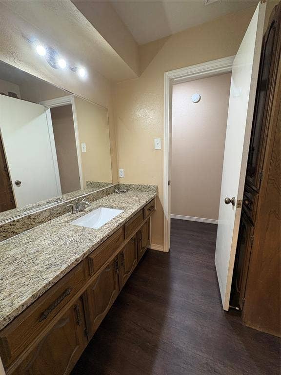 1025 Cloverdale Lane, DeSoto, TX 75115 Dual vanity with a light-colored countertop and integrated sink, set against a full-width mirror