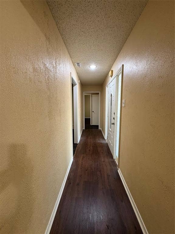 1025 Cloverdale Lane, DeSoto, TX 75115 Long hallway featuring wood-finish flooring, recessed lighting, and a paneled entry door
