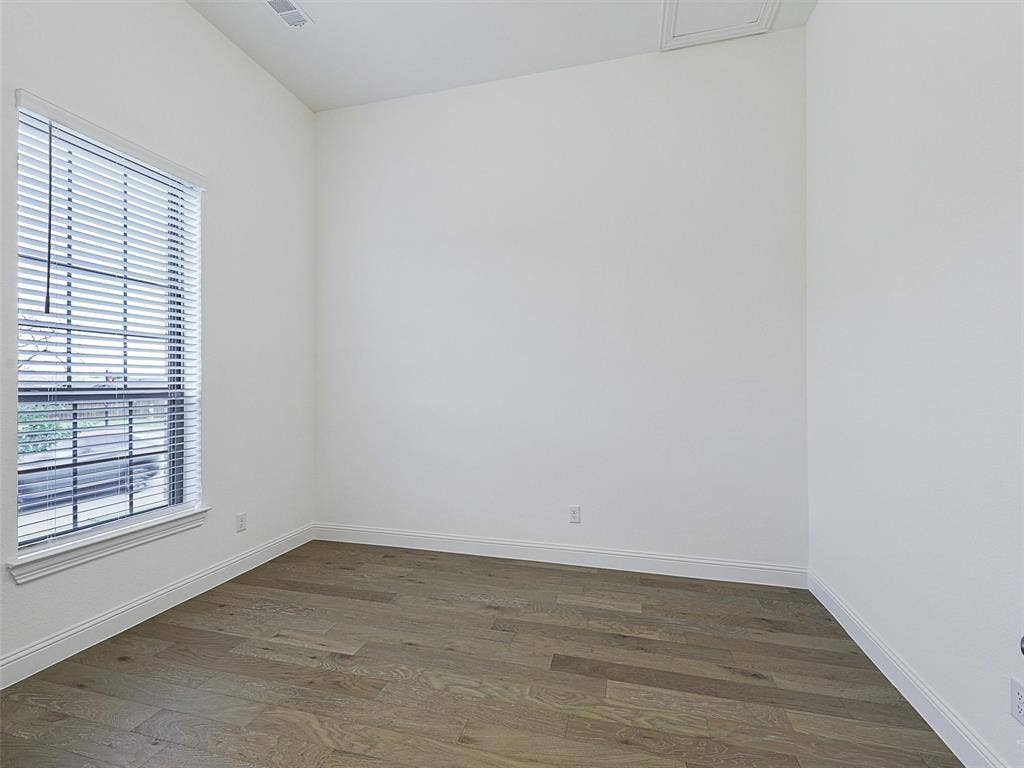 8305 Pine Island Way, McKinney, TX 75071 Wood-finish flooring, white walls, and a window with blinds