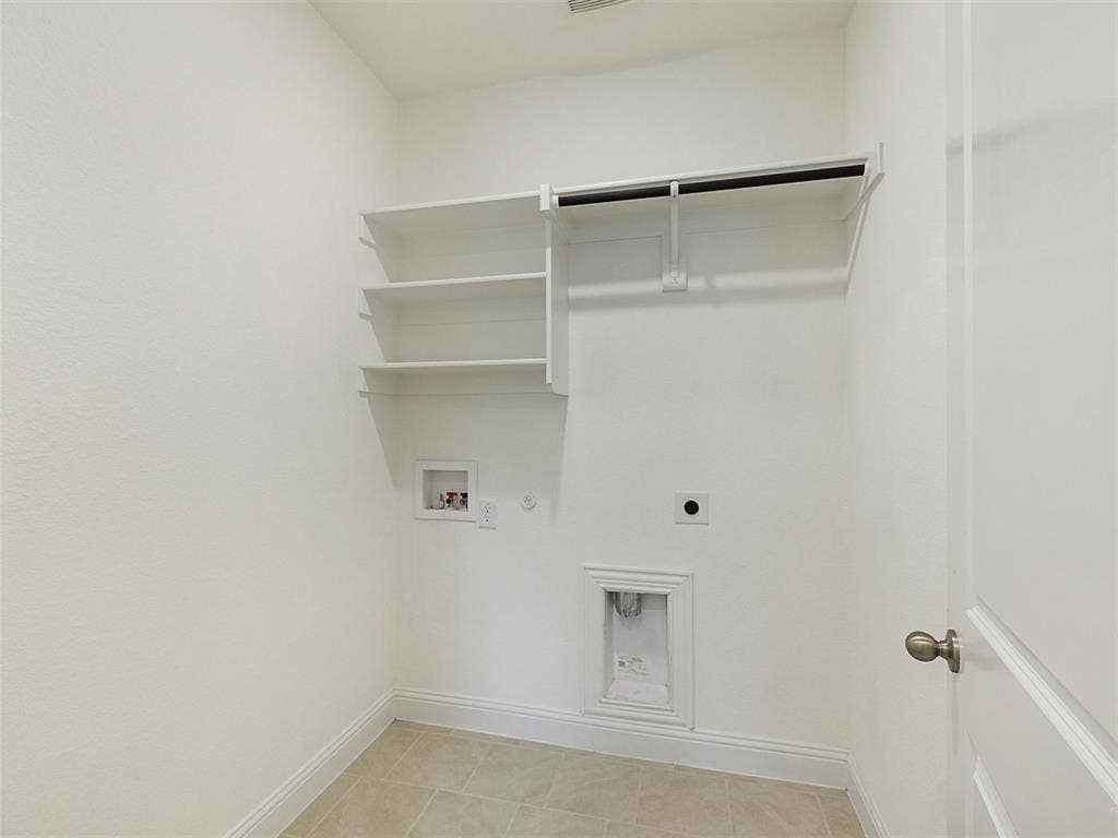 8305 Pine Island Way, McKinney, TX 75071 Tile flooring with built-in shelving, a clothes rod, and utility hookups