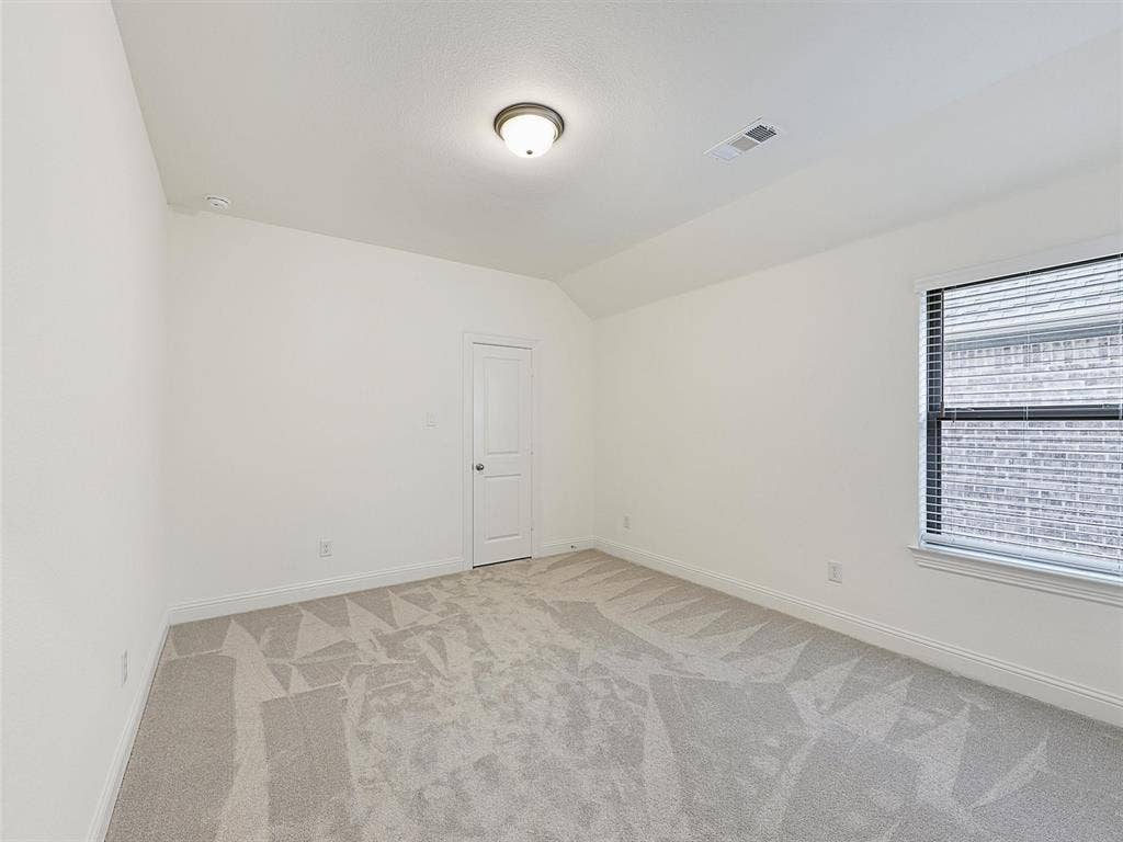 8305 Pine Island Way, McKinney, TX 75071 Neutral-toned carpeting, white painted walls, and a recessed window with blinds