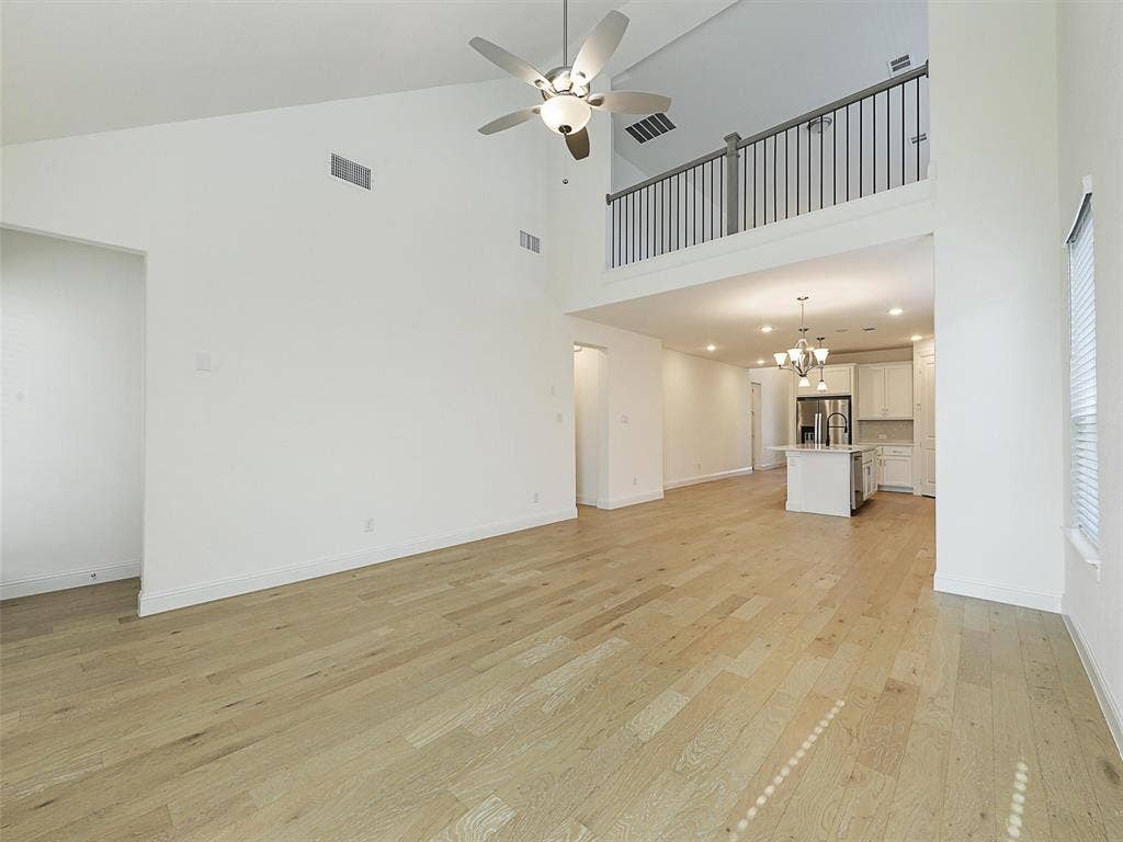 8305 Pine Island Way, McKinney, TX 75071 High ceilings with a ceiling fan, wood-finish flooring, and an open concept layout