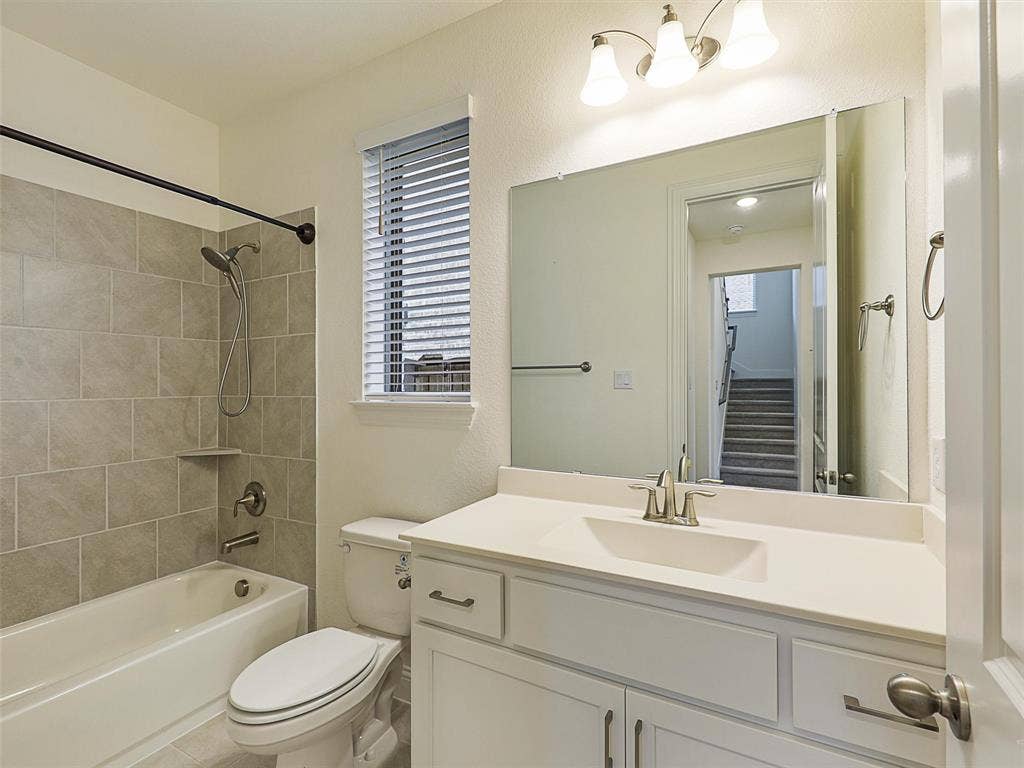 8305 Pine Island Way, McKinney, TX 75071 Tub/shower combination with subway tile surround, integrated shelf, and brushed nickel fixtures
