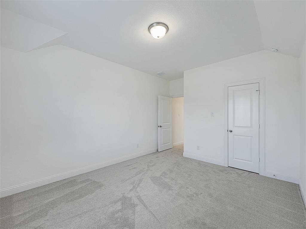 8305 Pine Island Way, McKinney, TX 75071 Spacious room with light gray carpet, white walls, and a semi-flush ceiling light fixture