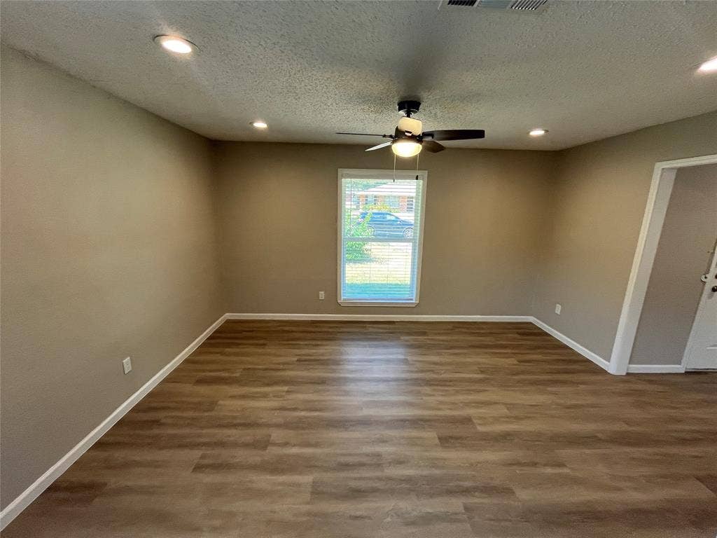Wood-finish flooring, recessed lighting, and a ceiling fan with integrated light fixture