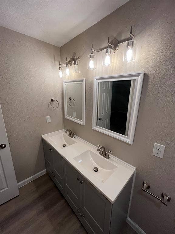 Dual vanity with integrated sinks, brushed nickel fixtures, gray cabinetry, and white countertops