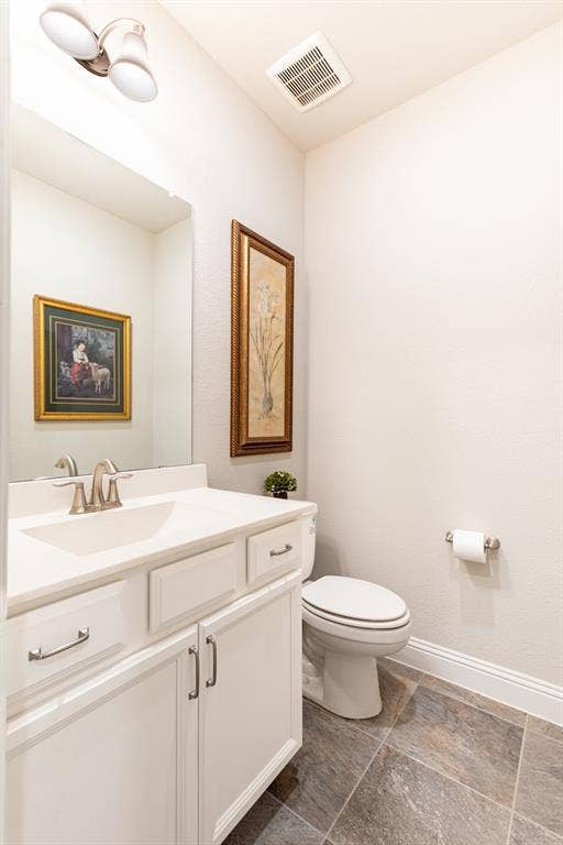 1101 10th Street, Argyle, TX 76226 Half bathroom is perfectly located off of the hallway by the utility room, garage door and office.