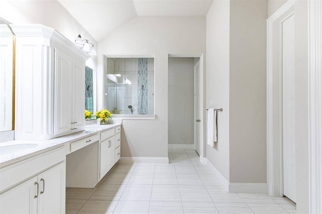 1101 10th Street, Argyle, TX 76226 Spacious primary bath with a walk-in shower, plenty of cabinet space, a linen closet and walk-in closet.