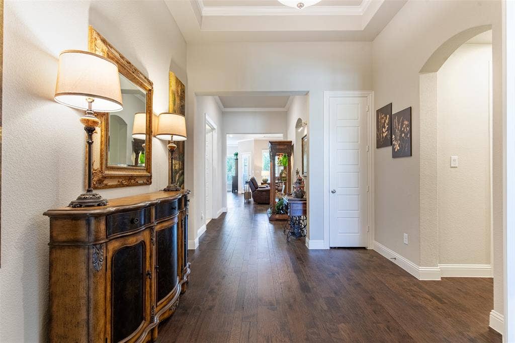 1101 10th Street, Argyle, TX 76226 What a stunning foyer with gleaming wood flooring! On the right, is a hallway that goes to the utility room, mudroom, and garage entrance as well as a powder bath.