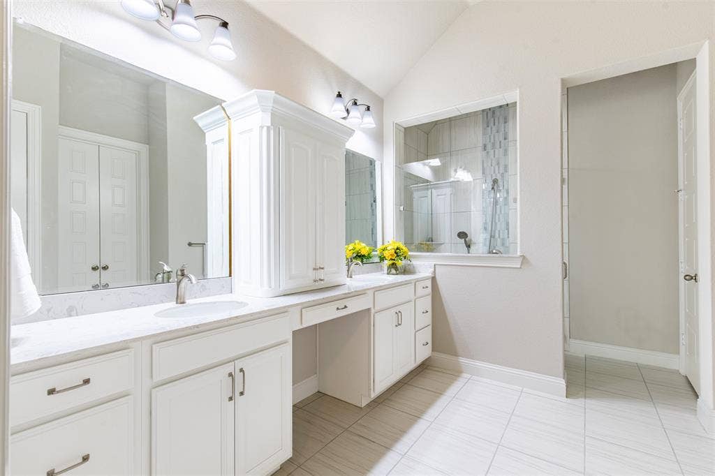 1101 10th Street, Argyle, TX 76226 This is a really large primary bathroom. Love the dual sinks with the cabinet separating the space.