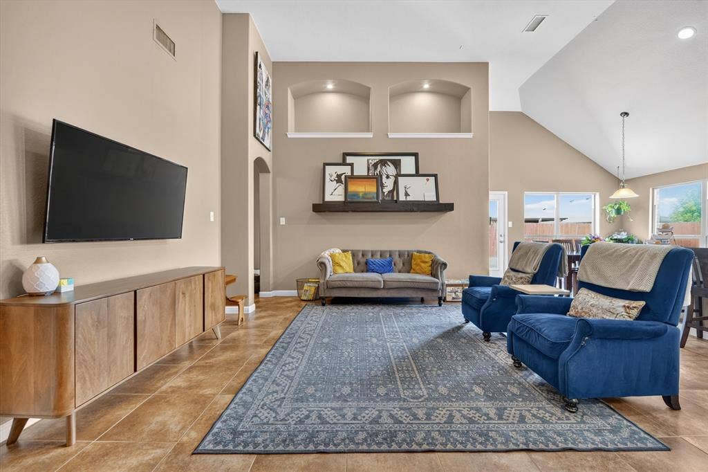 424 Foxcraft Drive, Fort Worth, TX 76131 Vaulted ceiling with an exposed beam, recessed wall niches with accent lighting, tile flooring, and multiple windows