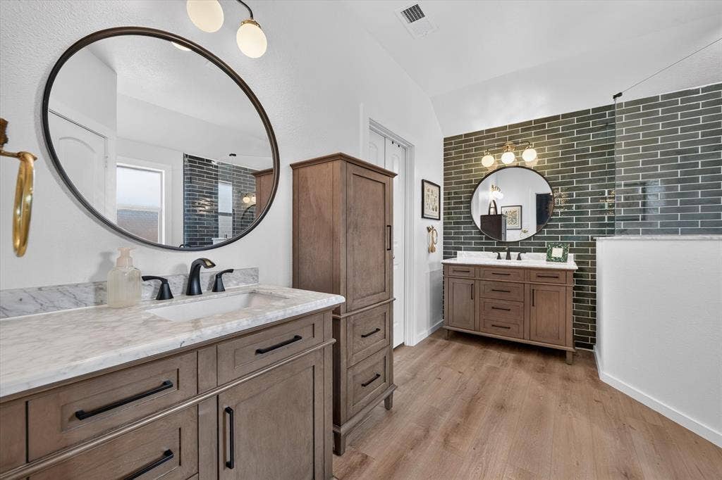 424 Foxcraft Drive, Fort Worth, TX 76131 Dual wood-finish vanities with undermount sinks and dark hardware