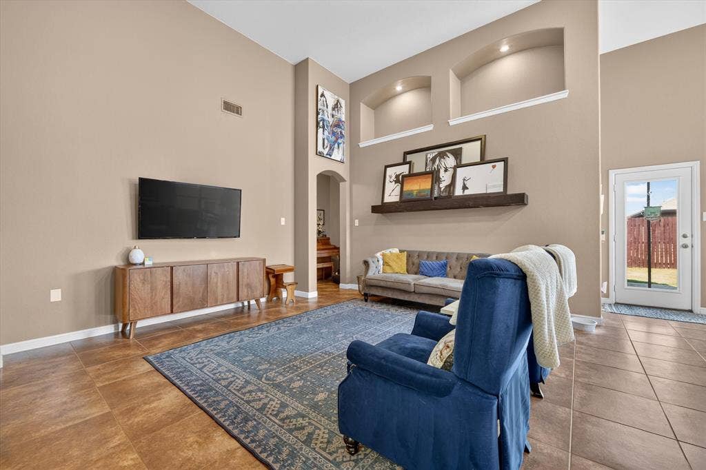 424 Foxcraft Drive, Fort Worth, TX 76131 Vaulted ceilings, archway, recessed wall niches with accent lighting, and a glass-paneled exterior door