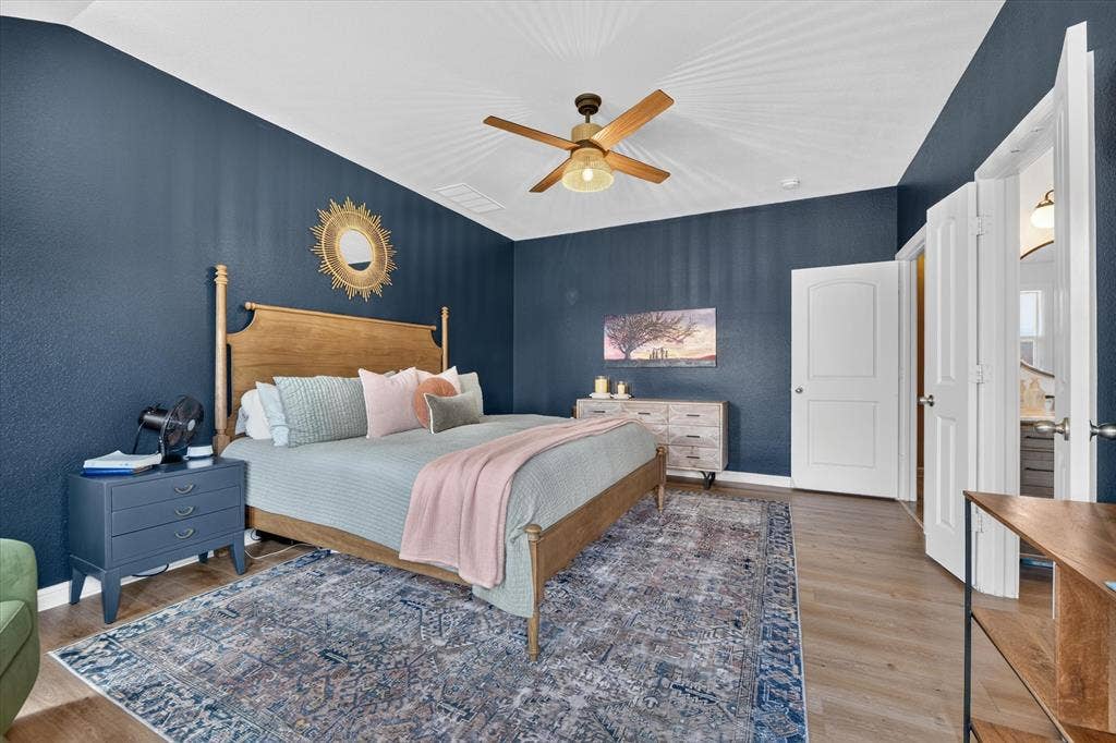 424 Foxcraft Drive, Fort Worth, TX 76131 Wood-finish flooring, accent wall, ceiling fan, and white interior doors
