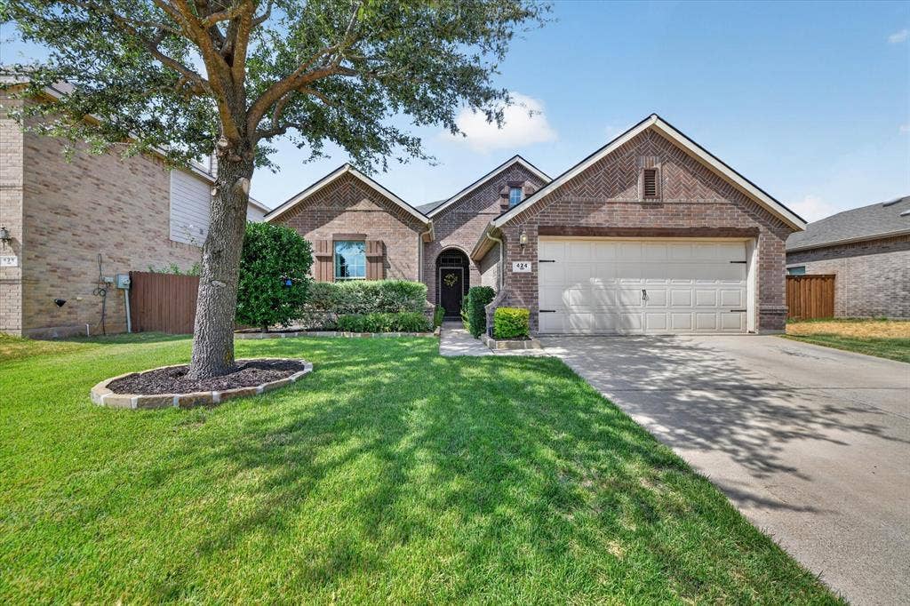 424 Foxcraft Drive, Fort Worth, TX 76131 Brick exterior with an arched entryway, attached garage, and a concrete driveway