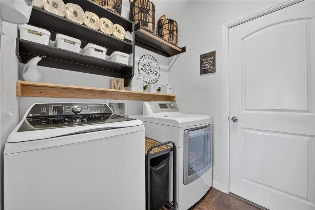 424 Foxcraft Drive, Fort Worth, TX 76131 Dedicated utility space featuring a washer and dryer, built-in shelving, and wood-finish flooring