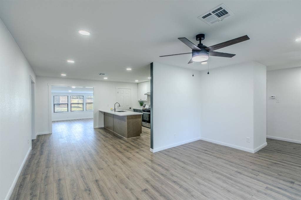 4133 Sherry Lane, Beverly Hills, TX 76711 Open-concept living space featuring wood-finish flooring throughout, recessed lighting, and a ceiling fan