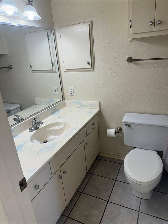 6050 Birchbrook Drive, #242, Dallas, TX 75206 White vanity with integrated sink, patterned countertop, and chrome faucet