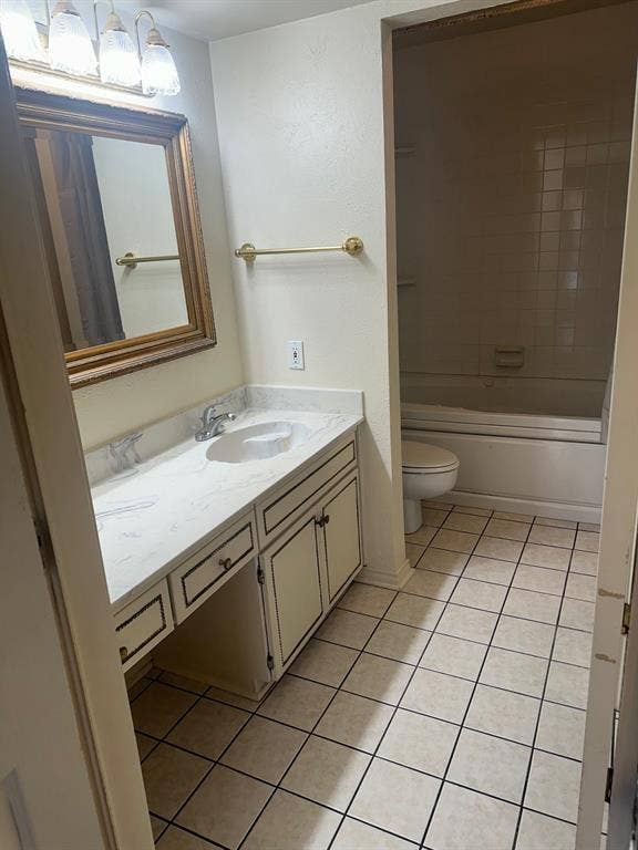 6050 Birchbrook Drive, #242, Dallas, TX 75206 Vanity with integrated sink, white countertop, and gold-framed mirror